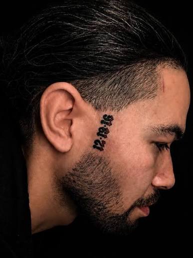 Small script face tattoo by Supremacy Ink